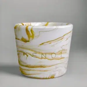 Gold round marble candle in a Jesmonite vessel