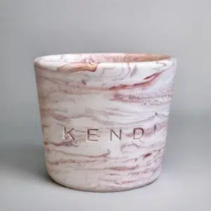 Terracotta round marble candle in a Jesmonite vessel
