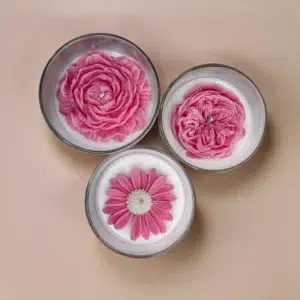 Detailed view of soy candle with wax flower in a glass jar