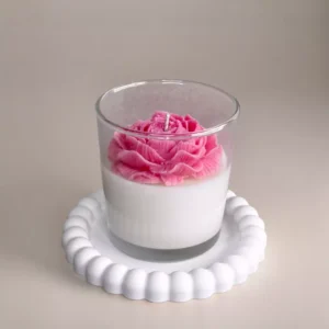 Soy candle with decorative wax flower in a glass container