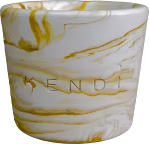 Handmade gold marble round candle in a Jesmonite vessel