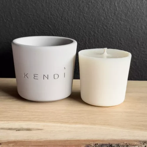 Refill for Round Scented Candle placed in an elegant plaster container.